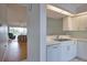 Open concept kitchen featuring white cabinets, a breakfast bar, and a view into the living room at 201 Silver Lake Dr # 204, Venice, FL 34292