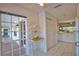 Clean kitchen with white cabinets, tile flooring, and adjacent breakfast nook with lots of natural light at 201 Silver Lake Dr # 204, Venice, FL 34292