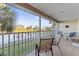 Screened lanai with table and chairs overlooking the lake at 201 Silver Lake Dr # 204, Venice, FL 34292