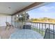 Screened lanai overlooking a lake with table and chairs at 201 Silver Lake Dr # 204, Venice, FL 34292