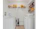 Functional laundry room with white washer and dryer and wire shelving for organized storage at 201 Silver Lake Dr # 204, Venice, FL 34292