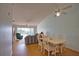 Spacious living room with ceiling fan, slider to porch, and a glimpse of the dining area at 201 Silver Lake Dr # 204, Venice, FL 34292