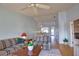Living room and dining room combination with ceiling fan, pass-through to kitchen, and furniture at 201 Silver Lake Dr # 204, Venice, FL 34292