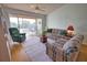 Living room with slider to porch with water view and comfortable seating at 201 Silver Lake Dr # 204, Venice, FL 34292
