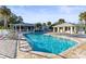 Community pool with lounge chairs and patio area at 201 Silver Lake Dr # 204, Venice, FL 34292
