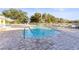 Community pool with patio and lounge chairs at 201 Silver Lake Dr # 204, Venice, FL 34292