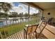 Screened porch with view of lake and foliage offers perfect place to relax and enjoy the scenery at 201 Silver Lake Dr # 204, Venice, FL 34292