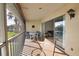Cozy screened porch with sliding doors offering lake view, seating, and access to bright, inviting interior at 201 Silver Lake Dr # 204, Venice, FL 34292
