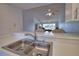 Kitchen sink and pass-through to the living room and dining room at 201 Silver Lake Dr # 204, Venice, FL 34292