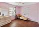 Pink walls, hardwood floors, and a chaise lounge in this bedroom at 2201 30Th N Ave, St Petersburg, FL 33713