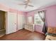 Another bedroom with pink walls, hardwood floors, and dresser at 2201 30Th N Ave, St Petersburg, FL 33713