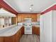 Kitchen with wood cabinets, white appliances, and a marble countertop at 2201 30Th N Ave, St Petersburg, FL 33713