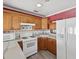 Kitchen with wood cabinets and white appliances at 2201 30Th N Ave, St Petersburg, FL 33713