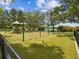 Playground area with swings and slides, surrounded by trees at 2201 30Th N Ave, St Petersburg, FL 33713
