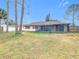 Large backyard with screened patio and mature trees at 23315 Charlston Pl, Land O Lakes, FL 34639