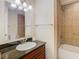 Clean bathroom with granite countertop and shower/tub combo at 23315 Charlston Pl, Land O Lakes, FL 34639