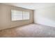 Spacious bedroom with neutral carpeting and large window at 23315 Charlston Pl, Land O Lakes, FL 34639
