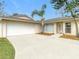 Front view of the house with white garage door at 23315 Charlston Pl, Land O Lakes, FL 34639