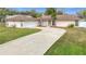 House exterior with white garage door and curved driveway at 23315 Charlston Pl, Land O Lakes, FL 34639