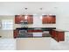 Kitchen with dark wood cabinets, granite counters, and island at 23315 Charlston Pl, Land O Lakes, FL 34639