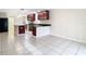 Open kitchen with stainless steel appliances and dark wood cabinets at 23315 Charlston Pl, Land O Lakes, FL 34639