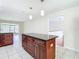 Kitchen island with dark wood cabinets and granite countertop at 23315 Charlston Pl, Land O Lakes, FL 34639