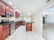 Modern kitchen featuring stainless steel appliances and dark wood cabinetry at 23315 Charlston Pl, Land O Lakes, FL 34639
