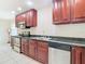 Kitchen with stainless steel appliances and dark wood cabinets at 23315 Charlston Pl, Land O Lakes, FL 34639
