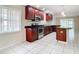 Kitchen features dark wood cabinets, granite counters, and stainless steel appliances at 23315 Charlston Pl, Land O Lakes, FL 34639