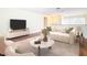 Living room features hardwood floors, stylish furniture, and a large TV at 23315 Charlston Pl, Land O Lakes, FL 34639