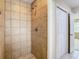 Large shower with tan tile surround at 23315 Charlston Pl, Land O Lakes, FL 34639