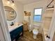 Modern bathroom with teal vanity, walk-in shower, and updated fixtures at 3409 Tarlton N St, St Petersburg, FL 33713