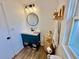 Updated bathroom with teal vanity, and modern fixtures at 3409 Tarlton N St, St Petersburg, FL 33713
