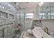 Modern bathroom with a glass-enclosed shower with a built-in seat at 4116 Ohio Ave, Tampa, FL 33616