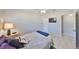 Comfortable bedroom features include wood floors, ceiling fan, and mounted television for relaxing evenings at 4116 Ohio Ave, Tampa, FL 33616