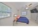 Comfortable bedroom features sleek floors, fan and lots of natural light at 4116 Ohio Ave, Tampa, FL 33616