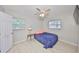 Cozy bedroom with a ceiling fan, wood floors, and a comfortable bed at 4116 Ohio Ave, Tampa, FL 33616