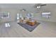 Spacious living room with light wood floors, a plush rug, and a comfortable sofa at 4116 Ohio Ave, Tampa, FL 33616