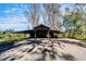 Exterior shot of a large barn on the property with multiple bays and plenty of open space at 4501 Keene Rd, Plant City, FL 33565