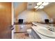 Sloped ceiling bathroom with single sink vanity, tile floor, and decor at 4501 Keene Rd, Plant City, FL 33565