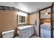 Bathroom features white cabinets, tile countertops, and a neutral wall color, creating a clean and well-lit space at 4501 Keene Rd, Plant City, FL 33565
