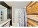 Bathroom featuring a wood accent wall and a white barn door style shower curtain at 4501 Keene Rd, Plant City, FL 33565