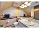 Sloped ceiling bathroom with single sink vanity and decor at 4501 Keene Rd, Plant City, FL 33565