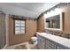 The bathroom features a neutral palette, tile counters, and framed windows, creating a clean and well-lit space at 4501 Keene Rd, Plant City, FL 33565