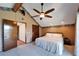 A bedroom featuring a king-sized bed, wooden closets, and a ceiling fan to provide a cozy and stylish living space at 4501 Keene Rd, Plant City, FL 33565