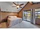 The bedroom includes balcony access, complemented by neutral carpeting and a ceiling fan to ensure comfort and relaxation at 4501 Keene Rd, Plant City, FL 33565
