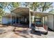 Exterior shot of the multiple carport featuring a tractor, truck, and other farm equipment at 4501 Keene Rd, Plant City, FL 33565