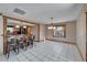 Dining area with tile floors, chandelier, and bar seating looking into the kitchen at 4501 Keene Rd, Plant City, FL 33565
