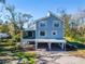 Charming two-story home featuring a screened porch, covered carport, and well-maintained landscaping at 4501 Keene Rd, Plant City, FL 33565