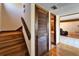 Hallway features wood flooring, wooden stairs, and a wooden door, offering access to a bathroom and other rooms at 4501 Keene Rd, Plant City, FL 33565